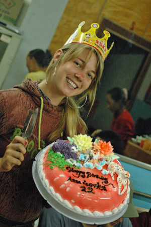 anna-with-her-22st-birthday-cake-featuring-the-old-man-yogi-puple-yak-and-spotted-dog